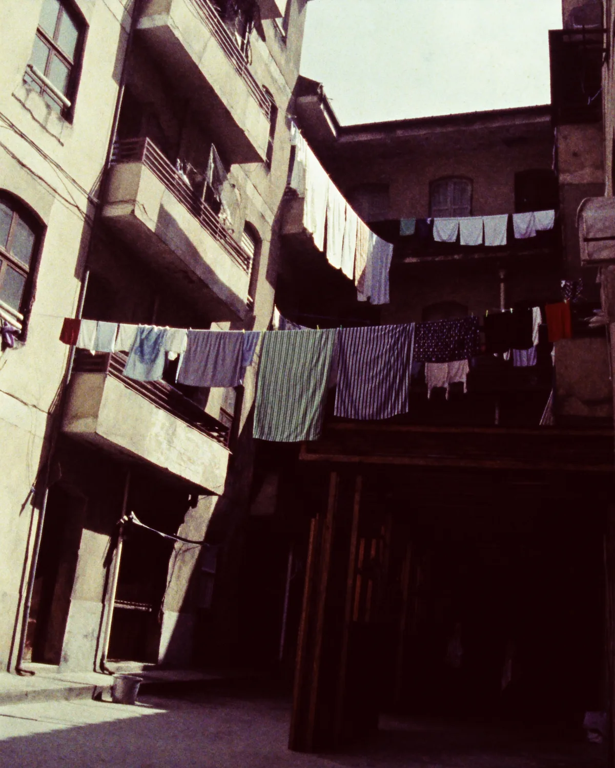 Washing lines strung between old courtyard balconies